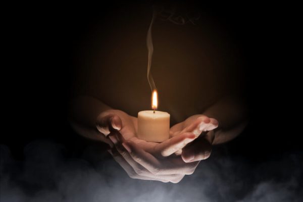 hands-holding-candle-scaled-e1663240176942.jpg